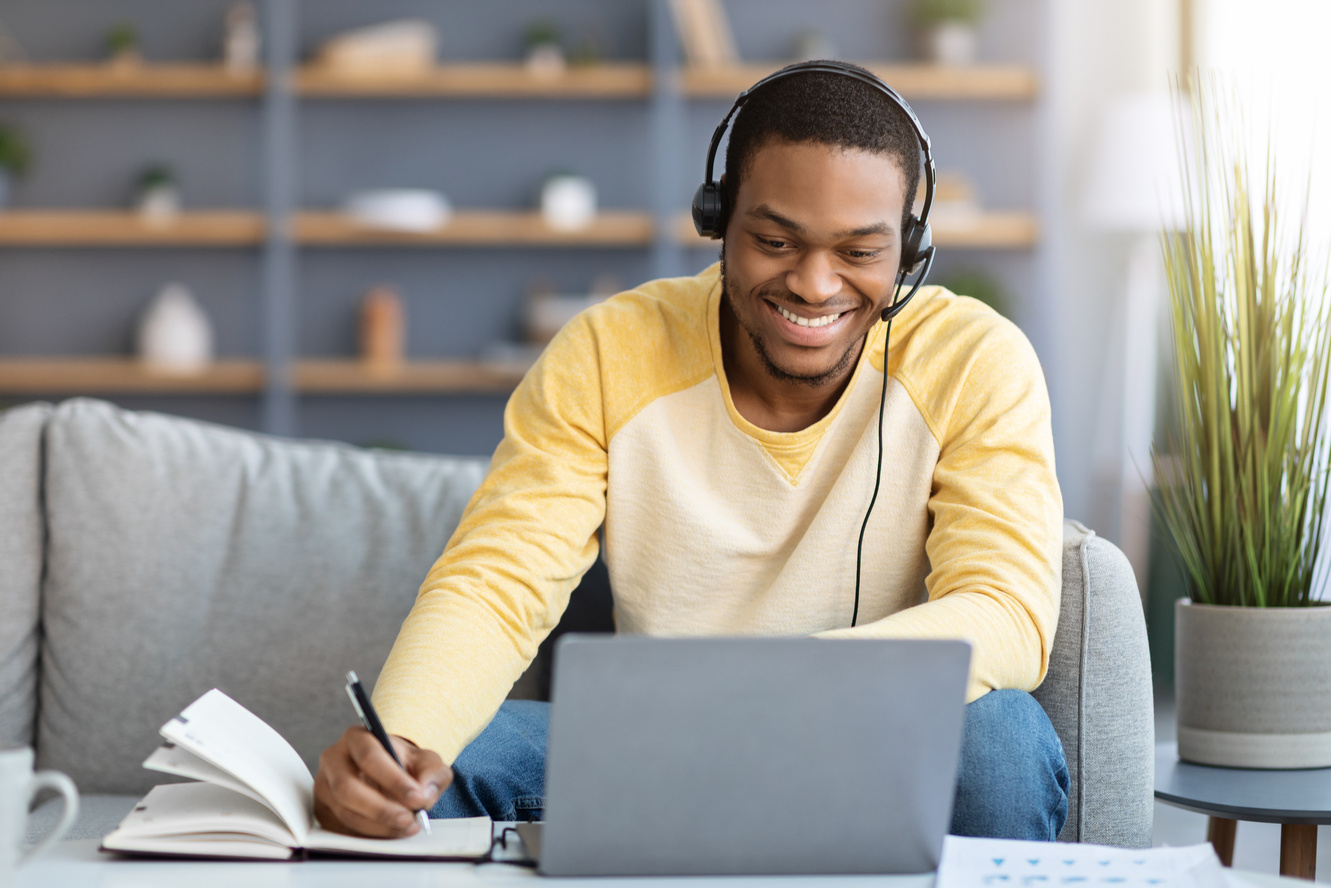 Man Taking Notes During Online Class